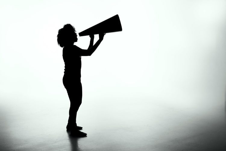 Woman in silhouette with megaphone