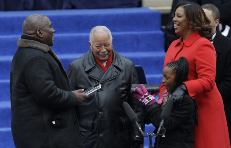 Dasani Coates, 11, holding the Bible for Letitia James at the January 2014 inaugurations of the administration of New York City Mayor Bill De Blasio