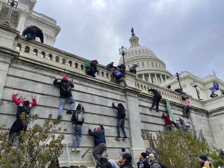 Pro-Trump rioters scale the walls of the U.S. Capitol on Jan. 6, 2021