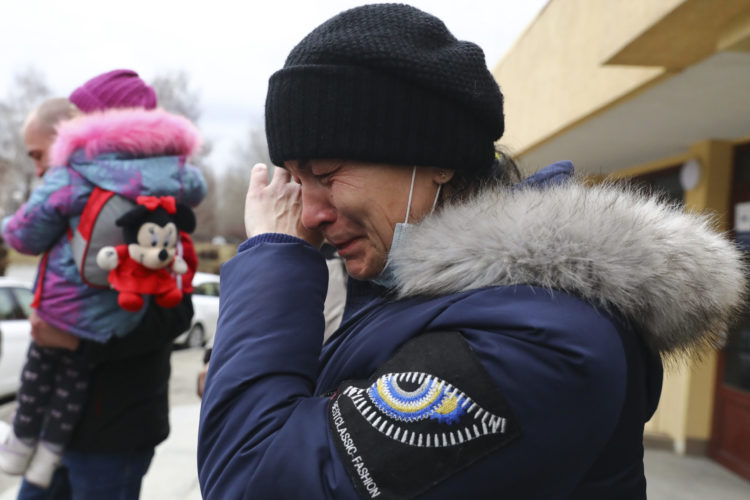 Ukrainian woman sobs after crossing border into Poland
