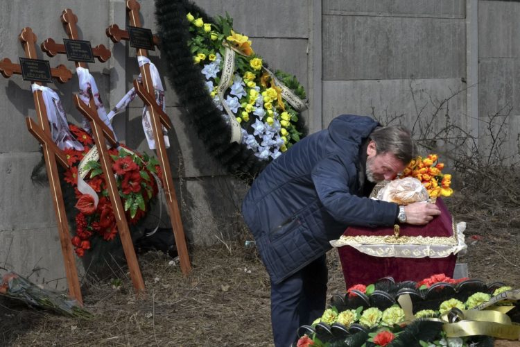A relative mourns a 3-year-old killed in the war in Ukraine