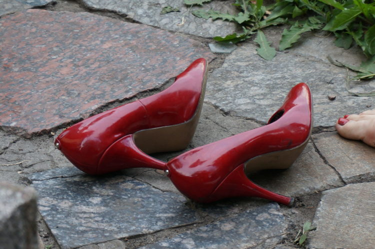 Red patent leather high heels set aside at a folk festival in Kyiv, Ukraine, in 2013