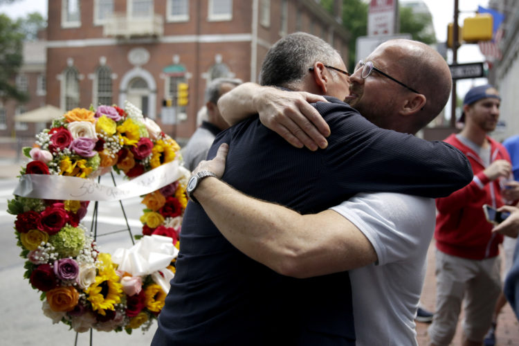 Jim Obergefell, left, the man behind the landmark 2015 Supreme Court gay marriage ruling, hugs Jeff Sigler of New York at the Gay Pioneers historical marker in Philadelphia in 2015.
