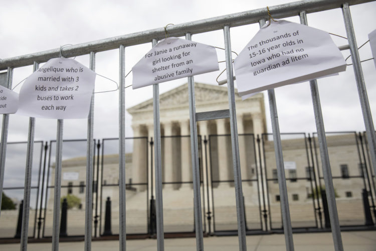 Abortion rights signs hang outside the U.S. Supreme Court in protest of the likelihood that the court will will overturn Roe v. Wade, the 1973 case that legalized abortion.