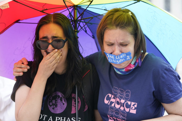 Young women react in tears to the U.S. Supreme Court ruling overturning Roe v. Wade