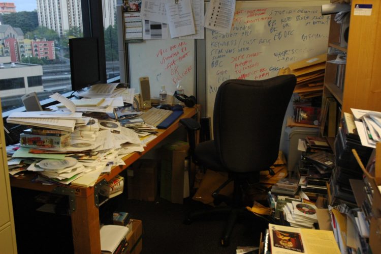 A cluttered desk and office