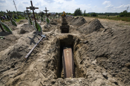 Coffins and graves at a mass burial ceremony for 21 unidentified persons killed by Russian troops in the Bucha town close to Kyiv, Ukraine