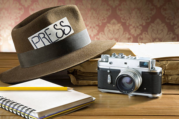 Fedora with PRESS label plus notebook and camera
