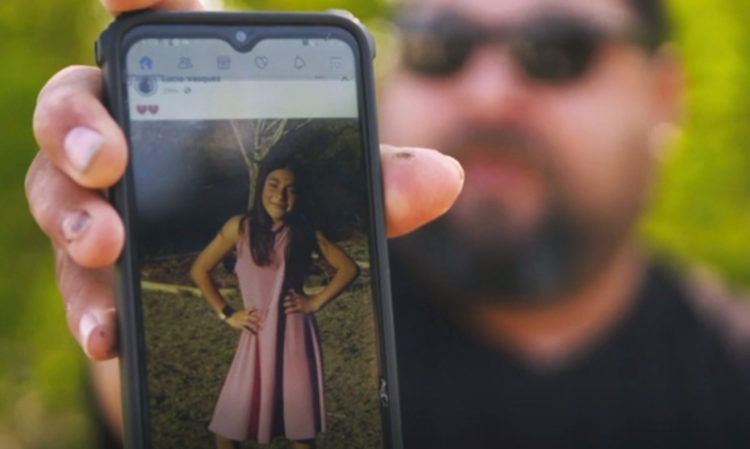The father of Jackie Cazares, who was one of the students killed at Robb Elementary School in Uvalde, Texas, shows a picture of her on his cell phone.