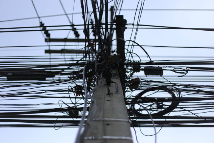 Photograph of tangled wires on a pole