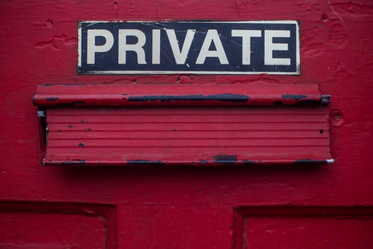 PRIVATE sign on a red-painted door.