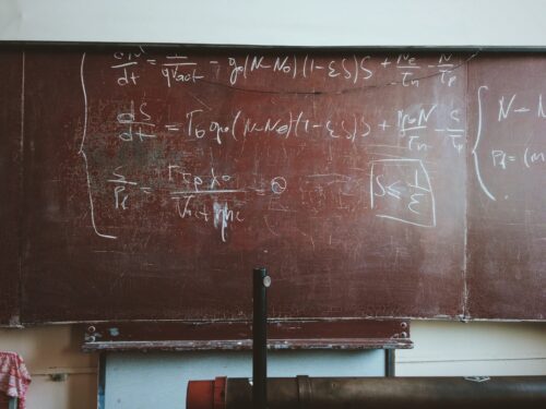 Photo of old chalkboard covered with math equations.