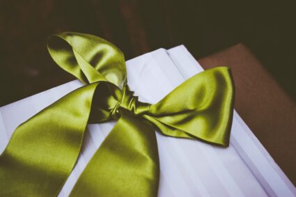 Green ribbon tied in a bow.