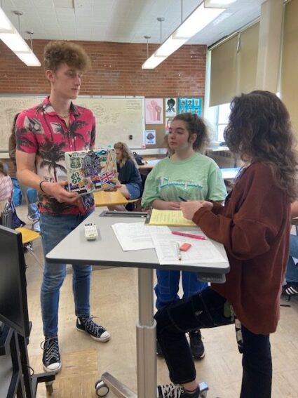 A reporter, left, meets with editors of The Headlight, the newspaper at Ida B. Wells High School in Portland, Oregon.