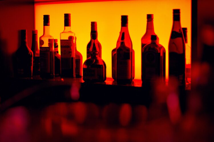 Bottles silhoutted in a tavern.