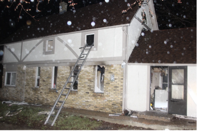 A two-story rental house in West Allis, Wisconsin, the night of an April 2013 fire that killed three young children.