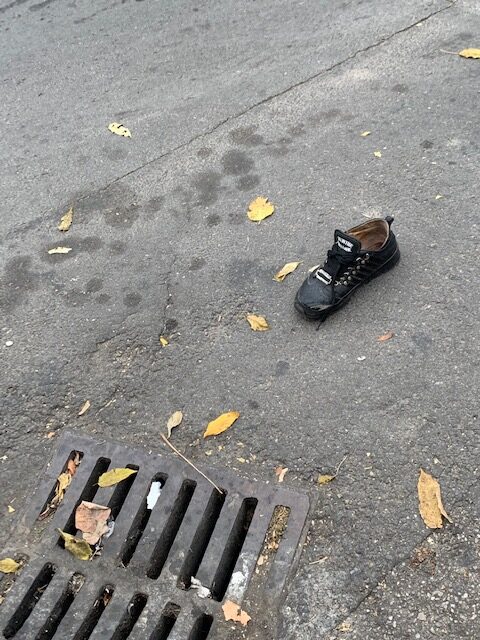 Photo of an abandoned shoe on a street in Bucharest, Romania.