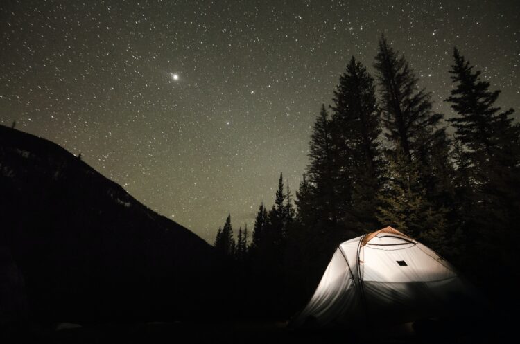 A tent under a starry night sky