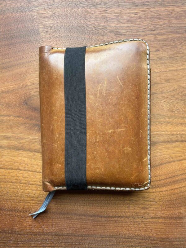 Leather cover for field reporting journal.