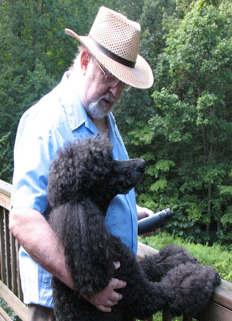 Pulitzer Prize winning journalist and narrative teacher Jon Franklin with his black poodle, Sam.