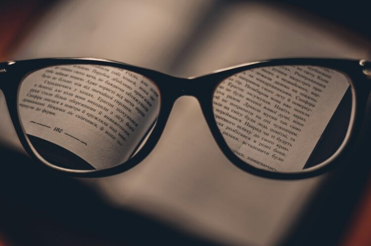 Eyeglasses on top of an open book