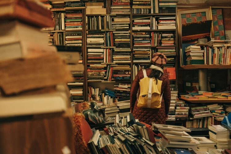 An unidentified reader browses the crowded shelves of a used bookstore