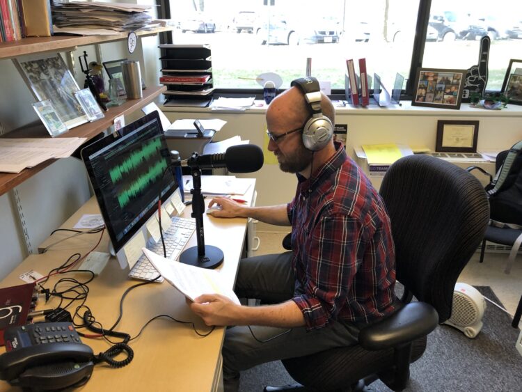 A photo of the late narrative journalist and educator Matt Tullis in his home studio, doing an episode of the podcast "Gangrey"