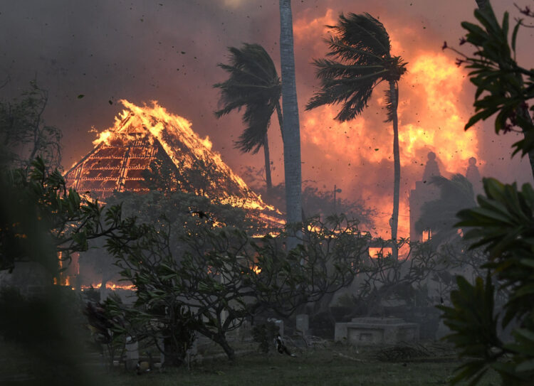 The historic Waiola Church in Lahaina and nearby Lahaina Hongwanji Mission ablaze in the August 2023 wildfire that destroyed much of the coastal town in Maui.