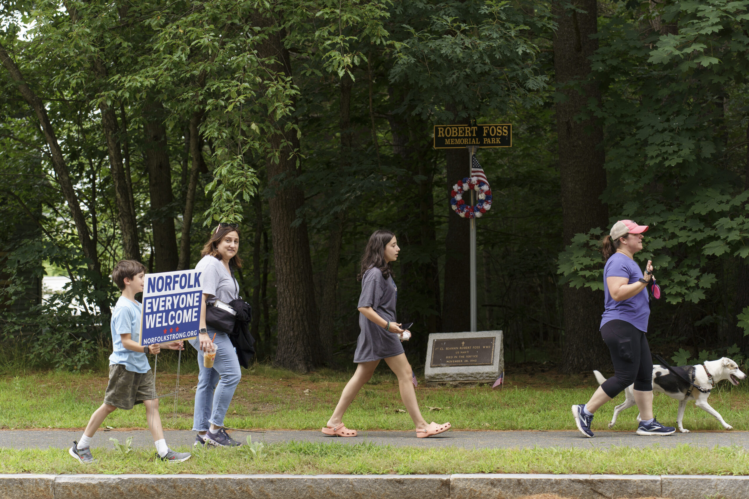 Residents who support a shelter for migrants in Norfolk, Mass., walk home after attending an event at the town’s library on June 27, 2024. (Jodi Hilton for The Washington Post via Getty Images) 