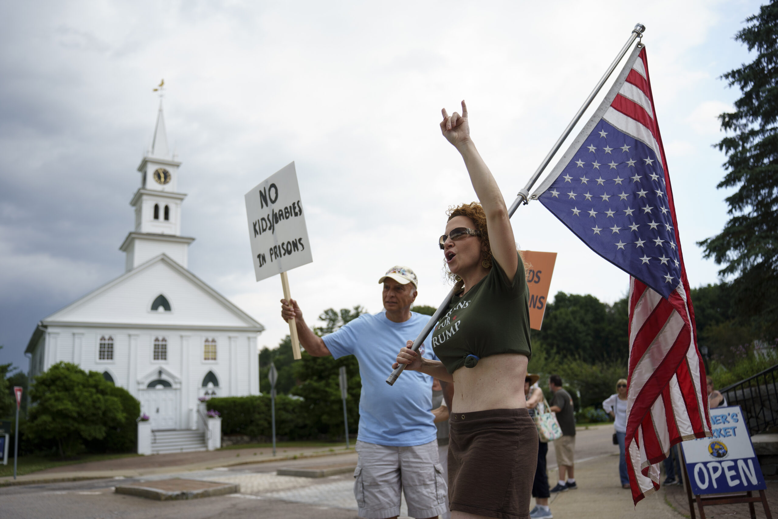 Protesters upset over a planned shelter for migrants in Norfolk, Mass., gather near the town center on June 26, 2024. (Jodi Hilton for The Washington Post via Getty Images)